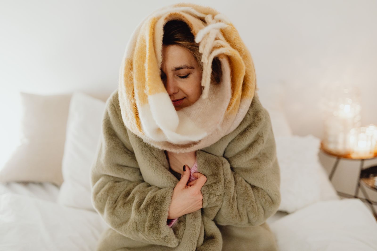 Freddo in casa: persona avvolta in una coperta prima di accendere il termoventilatore